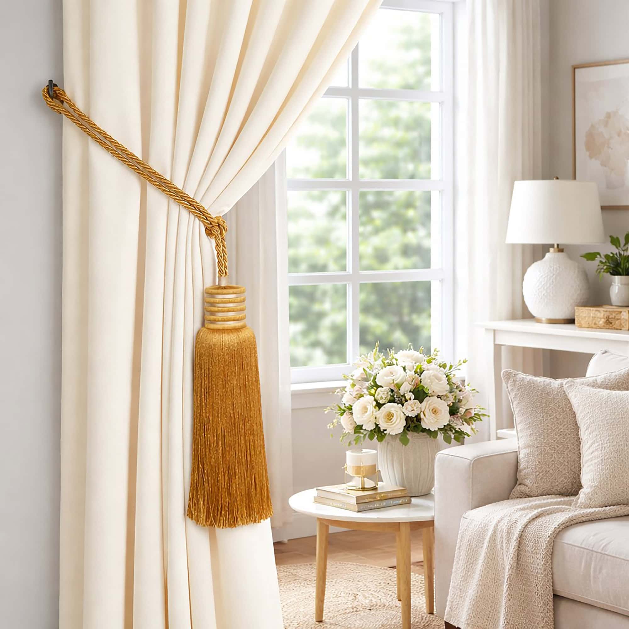 Golden amber tassel curtain tieback securing a cream drape beside a bright living room window
