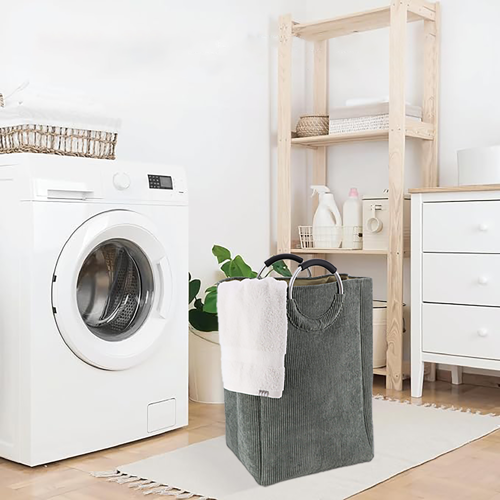 Sage green laundry hamper next to washer in modern laundry room