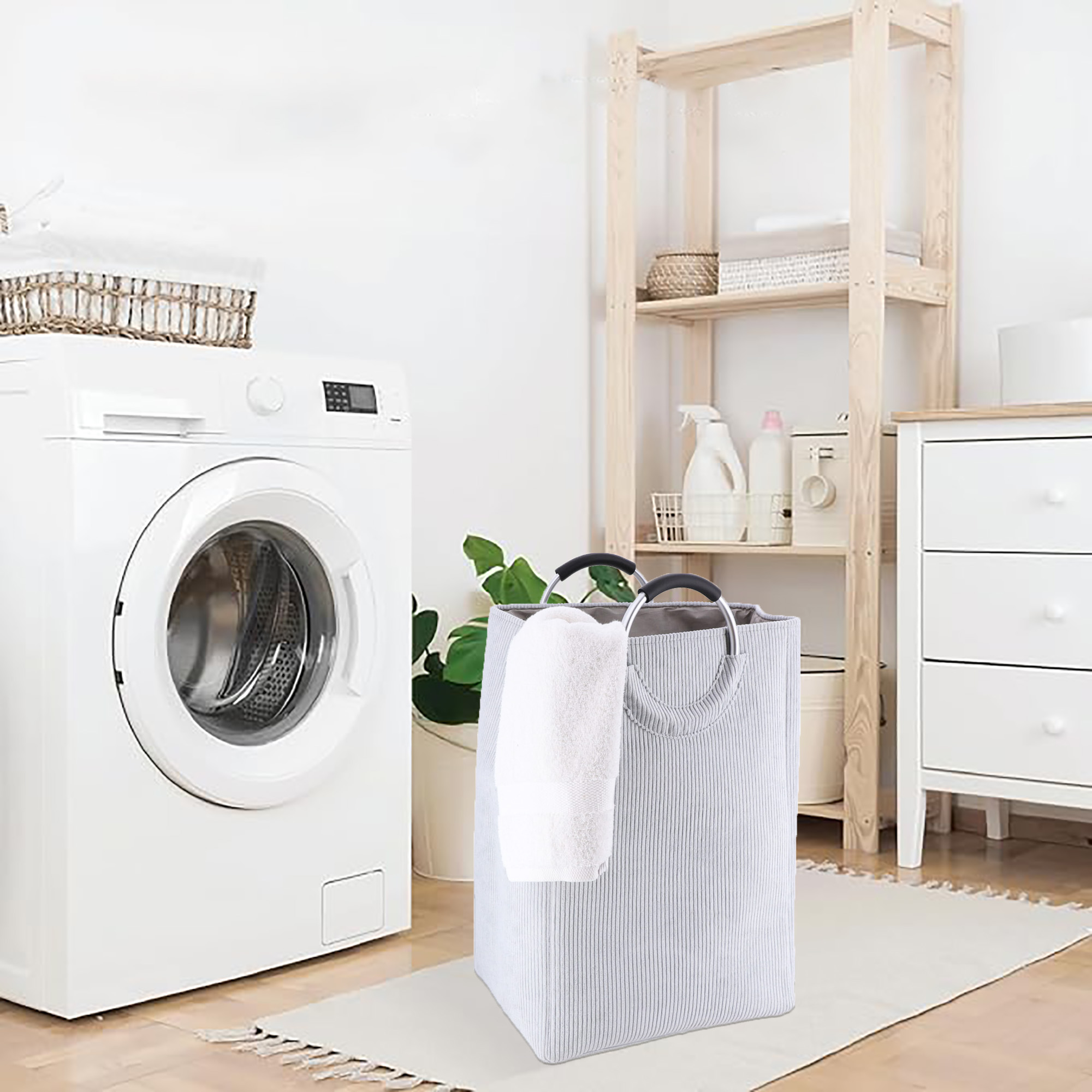 Soft gray laundry hamper next to washer in modern laundry room