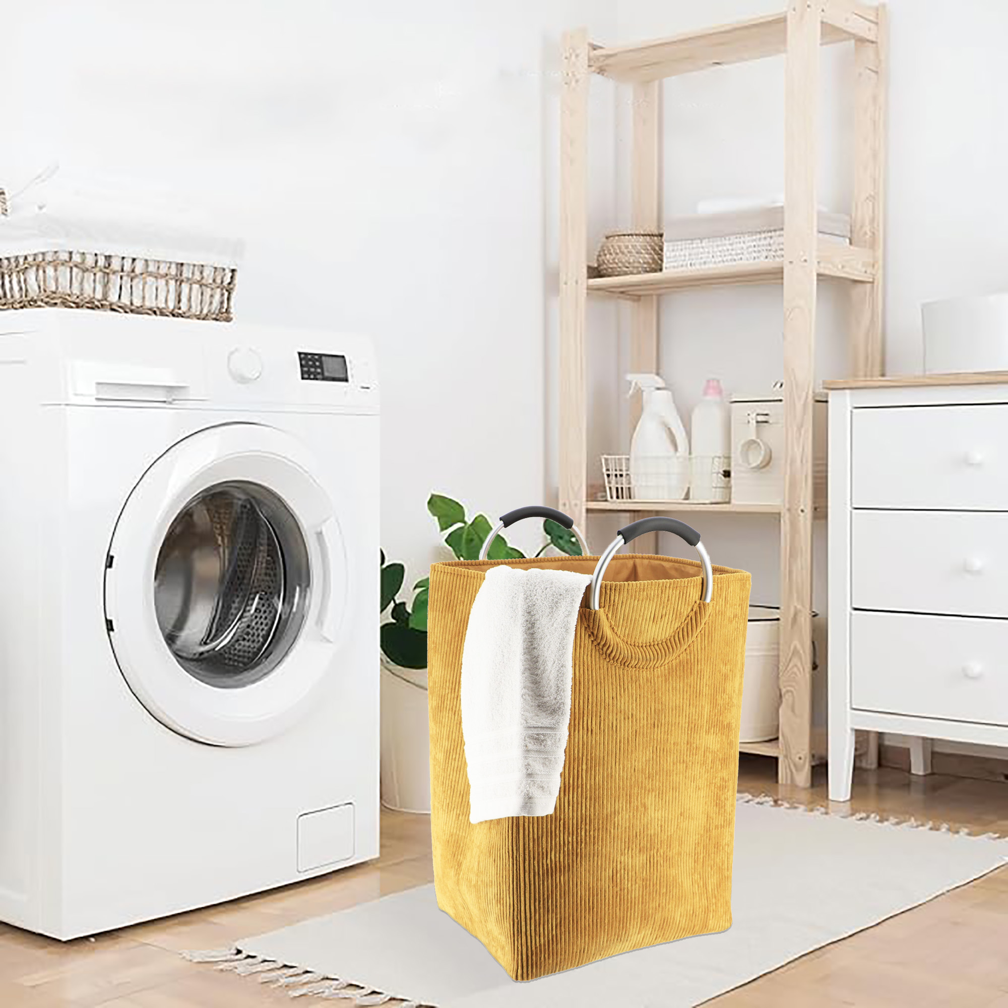 Mustard yellow laundry hamper next to washer in modern laundry room