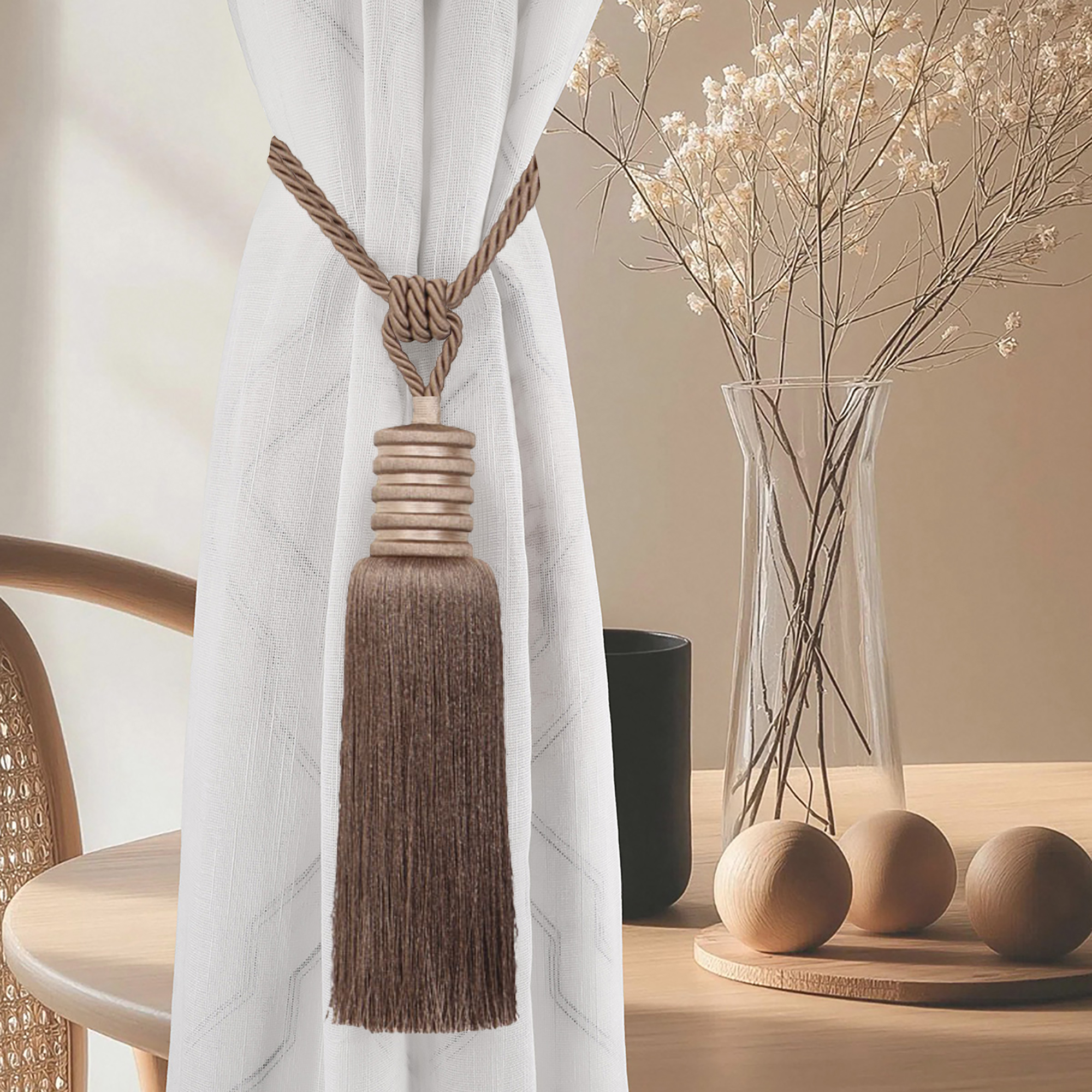 Mocha brown curtain tieback styled on white curtain in cozy modern room with wood accents and dried florals