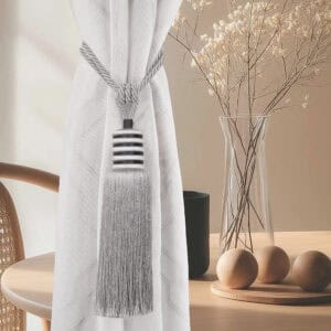 Silver mist tieback styled on curtain in neutral-toned interior, highlighting soft shimmer and clean contrast