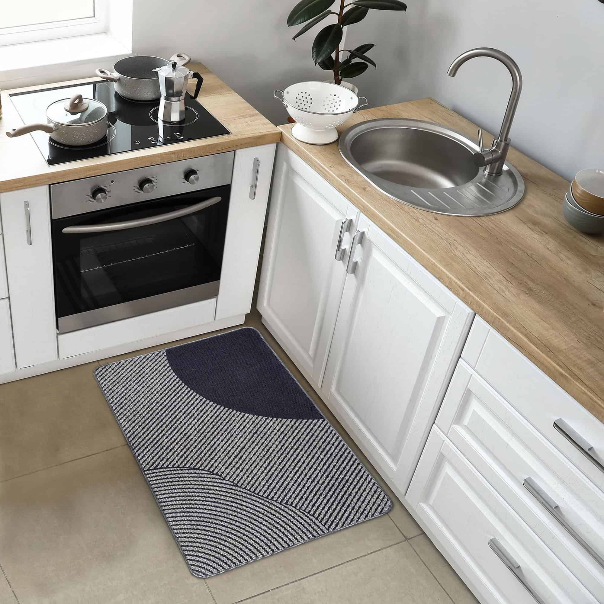 Kitchen mat placed in front of sink and stove in white modern kitchen setting