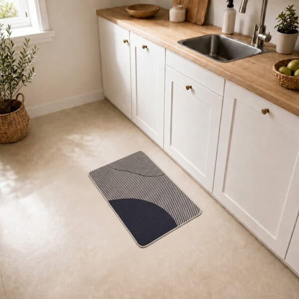 Beige geometric kitchen mat placed on tile floor beside a white sink cabinet, adding warm modern style to a bright kitchen space.