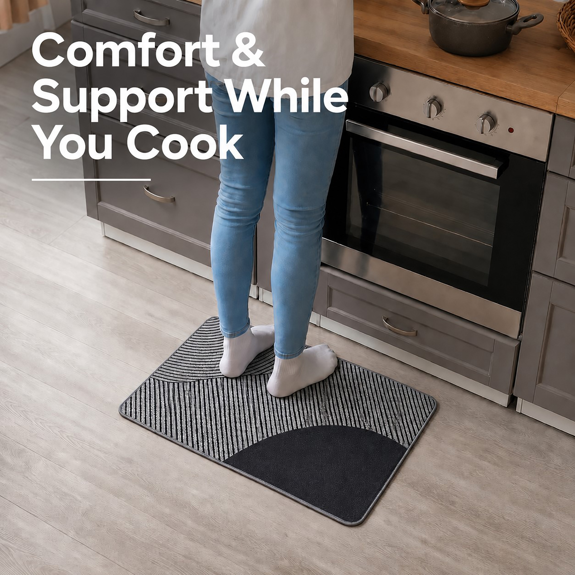 Person standing comfortably on a gray kitchen mat while cooking at the counter, cushioned support that eases pressure during long tasks.