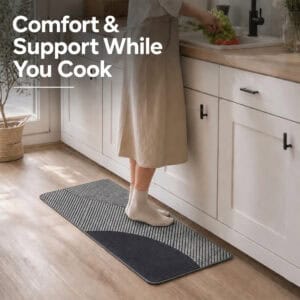 Person standing comfortably on a gray kitchen runner while cooking at the counter, cushioned support that eases pressure during long tasks.