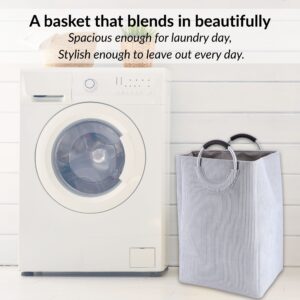 Laundry basket in soft gray beside washer in minimalist setup