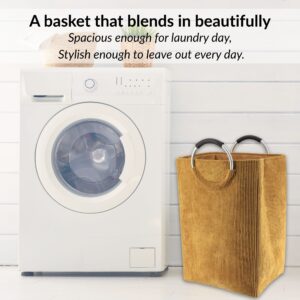 Laundry basket in mustard yellow beside washer in minimalist setup