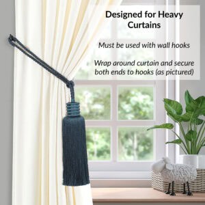 Deep teal curtain tieback wrapped around thick curtain and secured on both ends with wall hooks