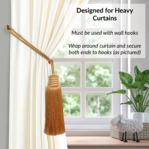 Golden amber curtain tieback wrapped around thick curtain and secured on both ends with wall hooks