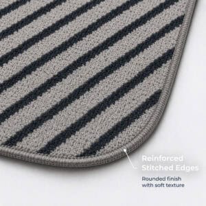 Close-up of gray kitchen mat corner showing reinforced stitched edges and a rounded soft-texture finish built to resist fraying over time.