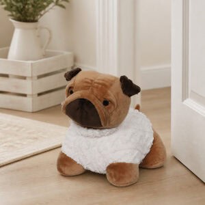 Tan pug door stopper propping open a white door on hardwood floor, wooden crate with a pitcher and plant in the background.