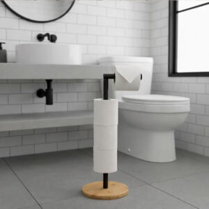 "Matte black freestanding toilet paper holder with bamboo base holding 4 rolls, next to toilet in modern white bathroom"