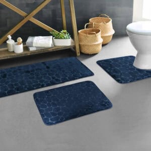 Navy blue pebble bathroom mat set styled in modern bathroom décor