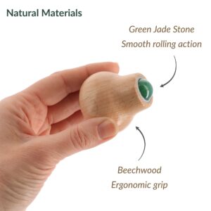 Close-up of wooden beechwood face roller with green jade stone