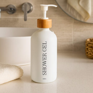 White shower gel bottle on bathroom counter with towel