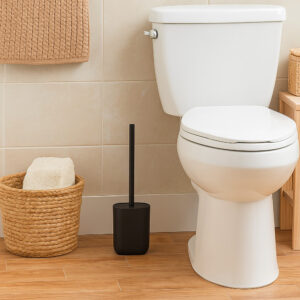 Black toilet brush holder placed beside toilet