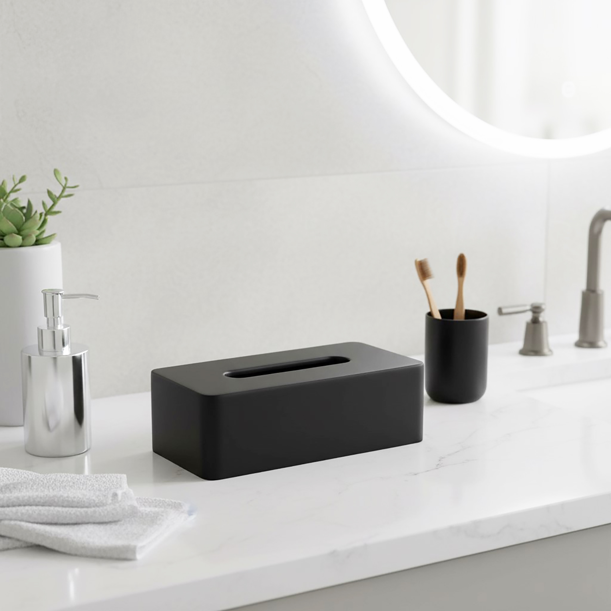 Black tissue box holder on bathroom counter