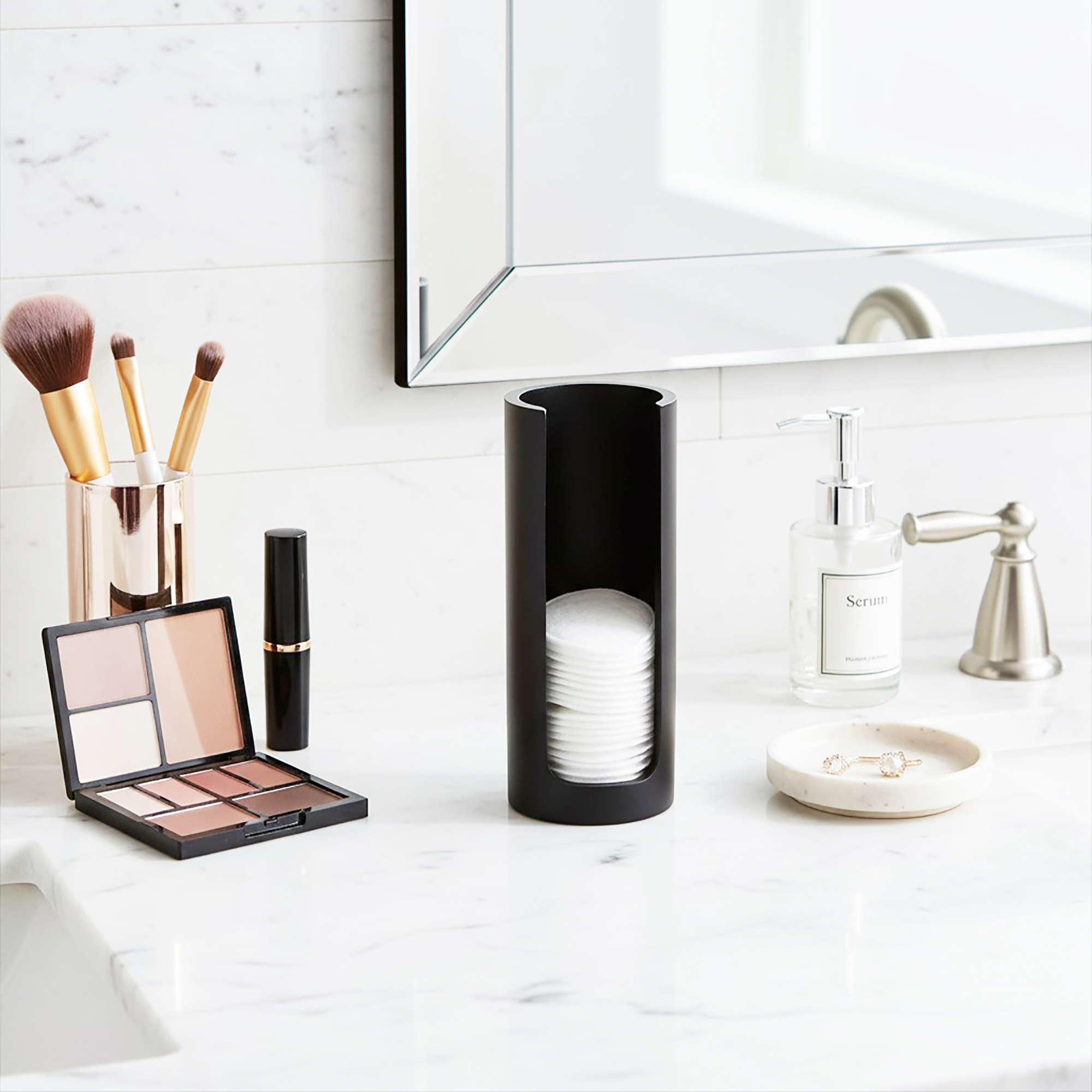 Black cotton pad holder on bathroom counter
