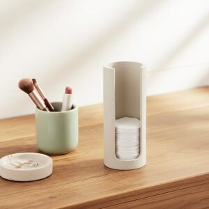 Beige cotton pad holder on bathroom counter