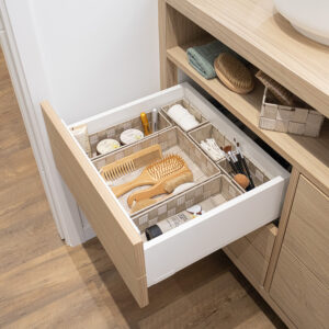 Beige drawer organizers arranged neatly in bathroom drawer