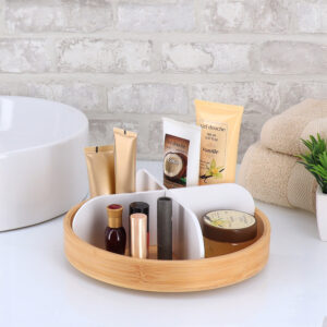 Bamboo vanity organizer with matte white dividers holding cosmetics on bathroom counter