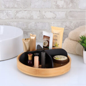 Bamboo vanity organizer with matte black dividers holding cosmetics on bathroom counter