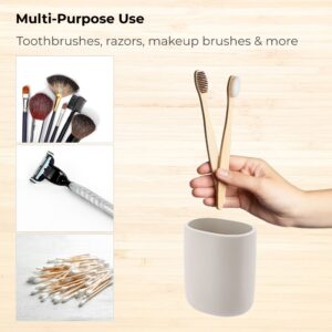 Beige tumbler shown with toothbrushes and grooming items