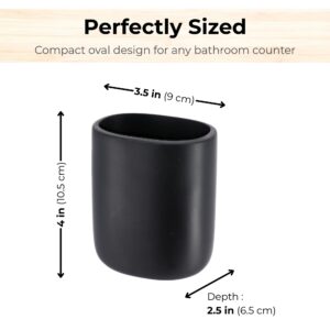 Black tumbler shown with toothbrushes and grooming items