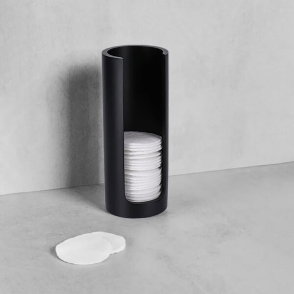 Black cotton pad holder with pads on counter