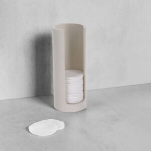 Beige cotton pad holder with pads on counter