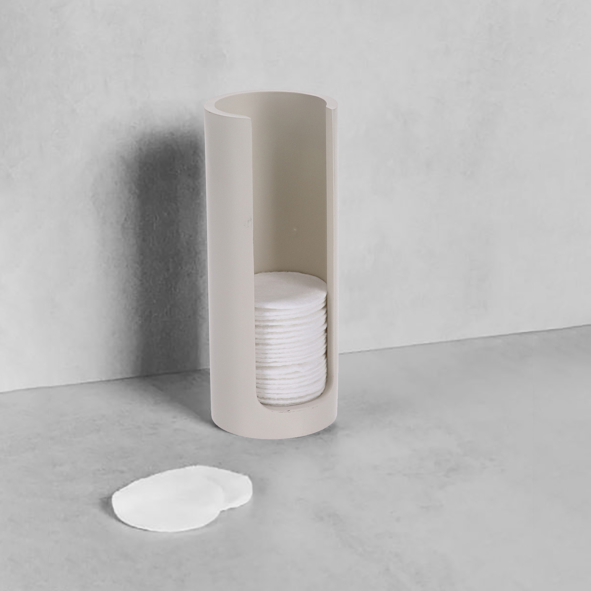 Beige cotton pad holder with pads on counter