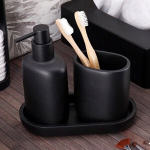Black oval tray holding soap dispenser and tumbler