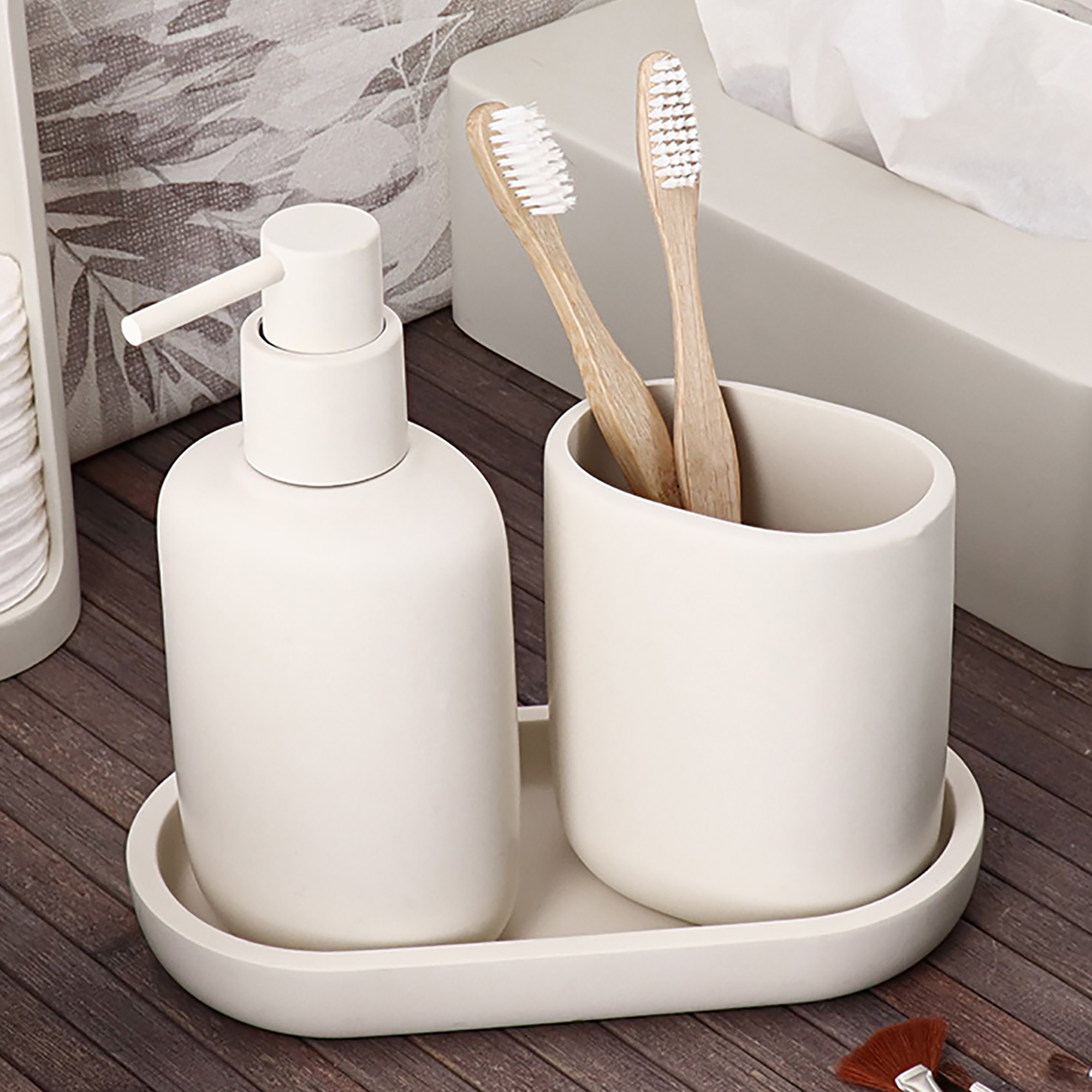 Beige oval tray holding soap dispenser and tumbler