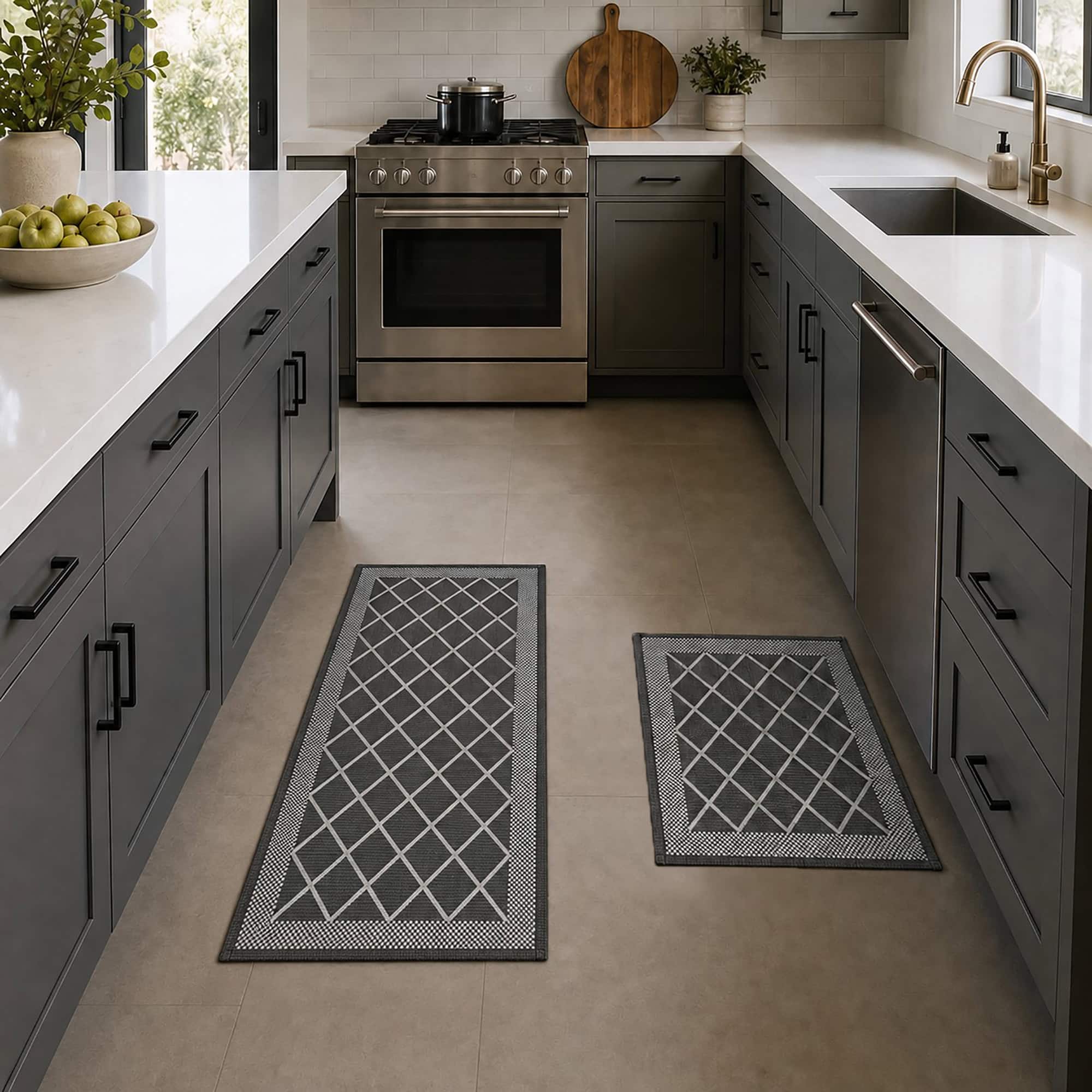 2- Charcoal gray diamond trellis kitchen mat and runner set on tile floor in a gray and stainless kitchen