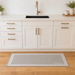 2- Kitchen runner mat in front of sink on wood floor, taupe with cream border and Kitchen lettering