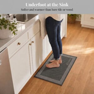 3- Barefoot person standing on charcoal kitchen mat with cream border at the sink, cushioned on hardwood floor