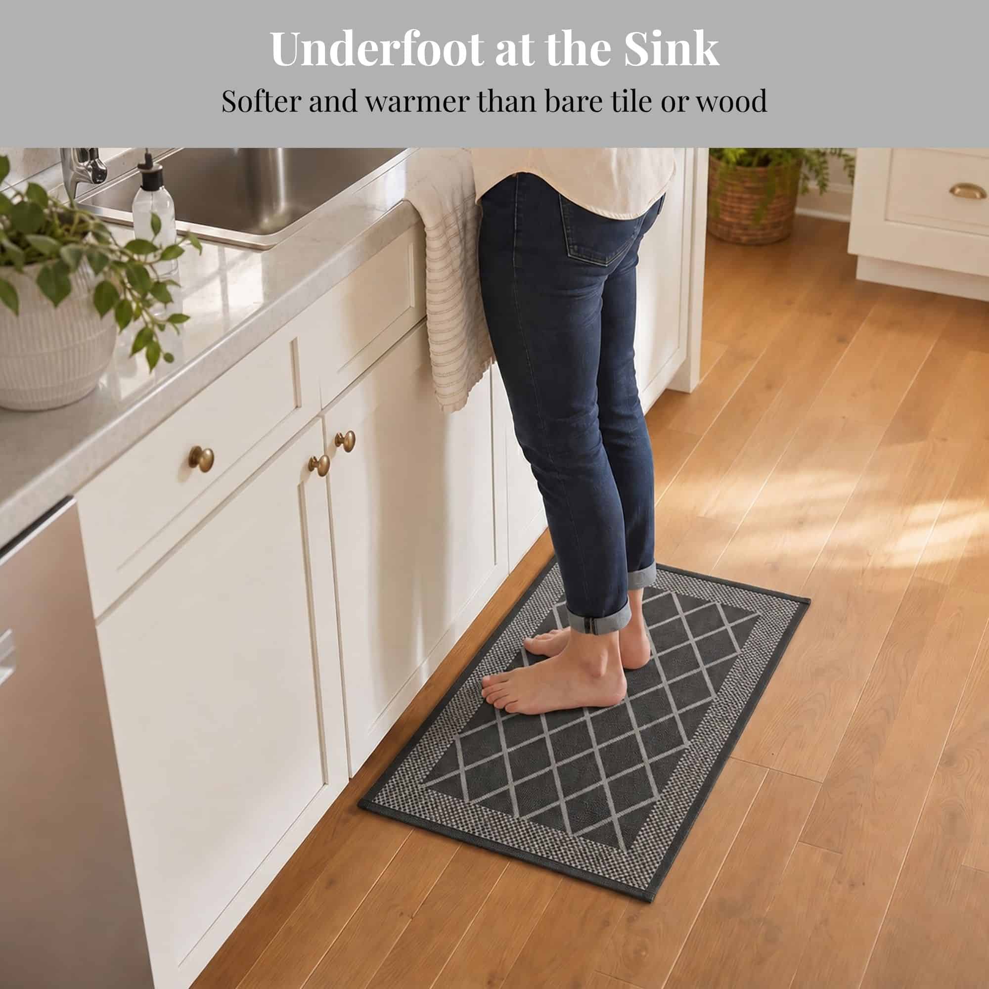 3- Barefoot person standing on charcoal gray kitchen mat at the sink, cushioned underfoot on hardwood floor