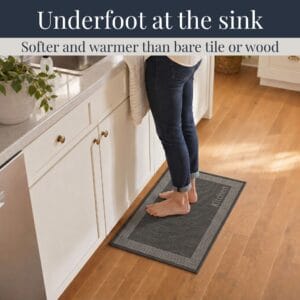3- Barefoot person standing on charcoal kitchen mat with cream border at the sink, cushioned on hardwood floor