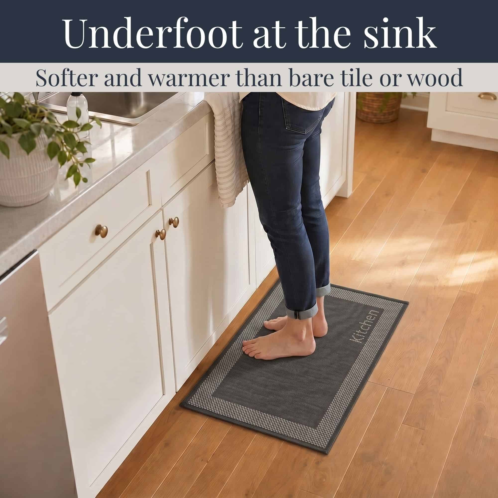 3- Barefoot person standing on charcoal kitchen mat with cream border at the sink, cushioned on hardwood floor