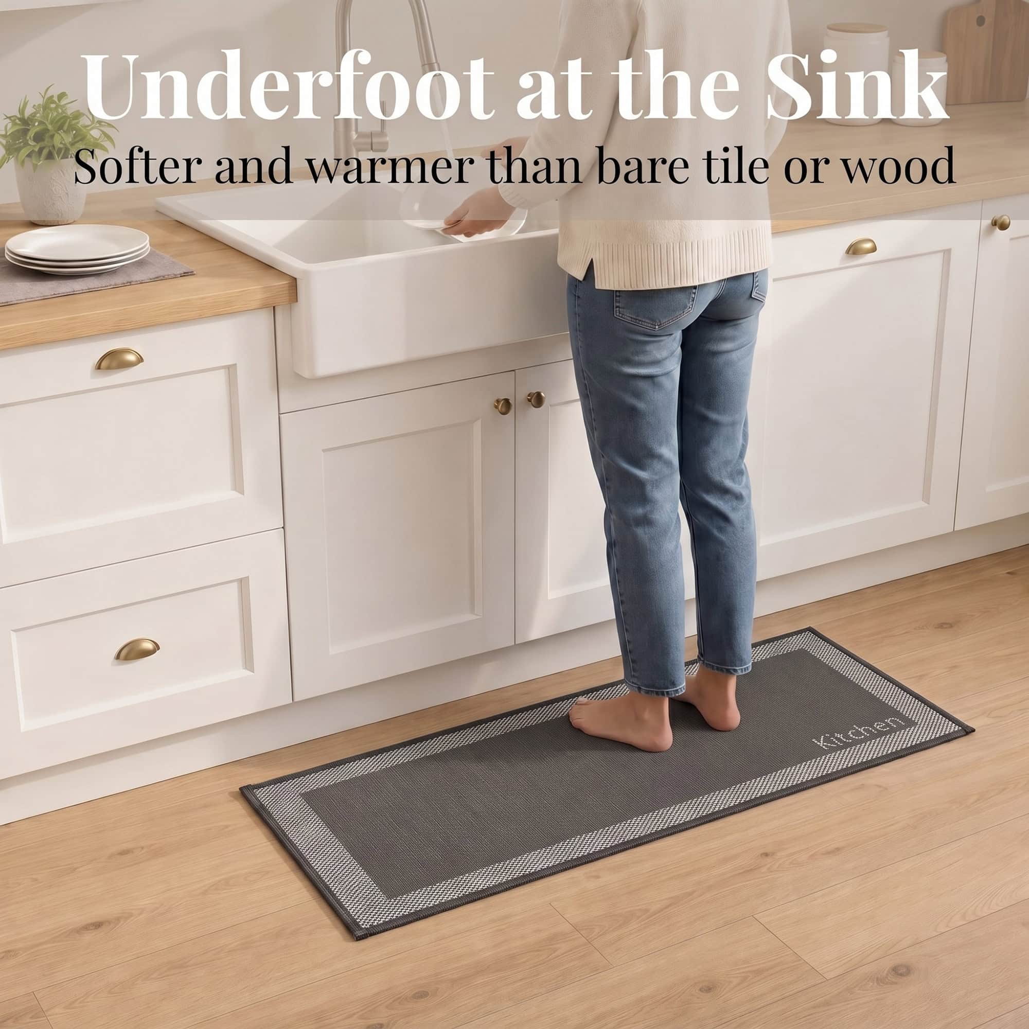 3- Barefoot person standing on charcoal kitchen runner with cream border at the sink, cushioned on wood floor