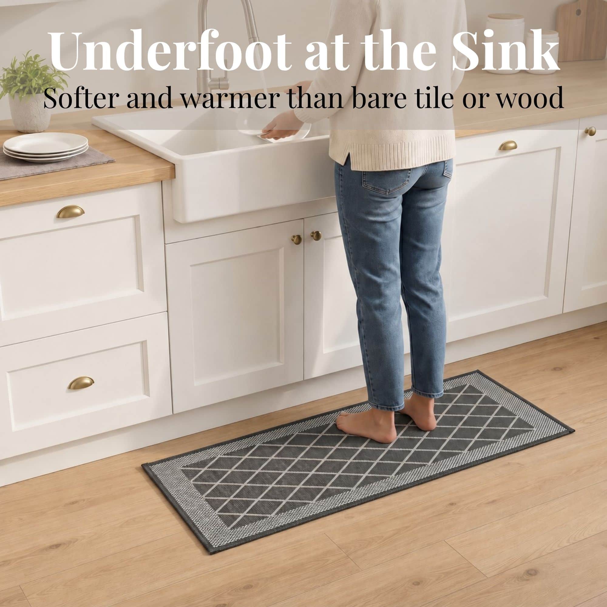 3- Barefoot person standing on charcoal gray diamond trellis kitchen runner at the sink, cushioned on wood floor