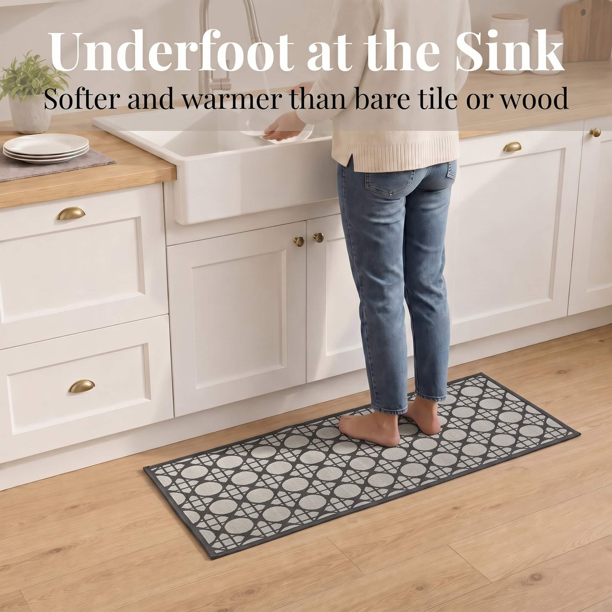 3- Barefoot person standing on cream and charcoal cane circle kitchen runner at the sink, cushioned on wood floor