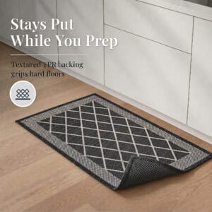 4- Charcoal gray kitchen mat with corner folded back to show textured TPR backing that grips hard floors