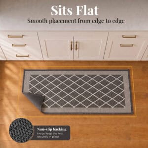 5- Charcoal gray diamond trellis kitchen runner lying flat, corner folded to show non slip backing on wood floor