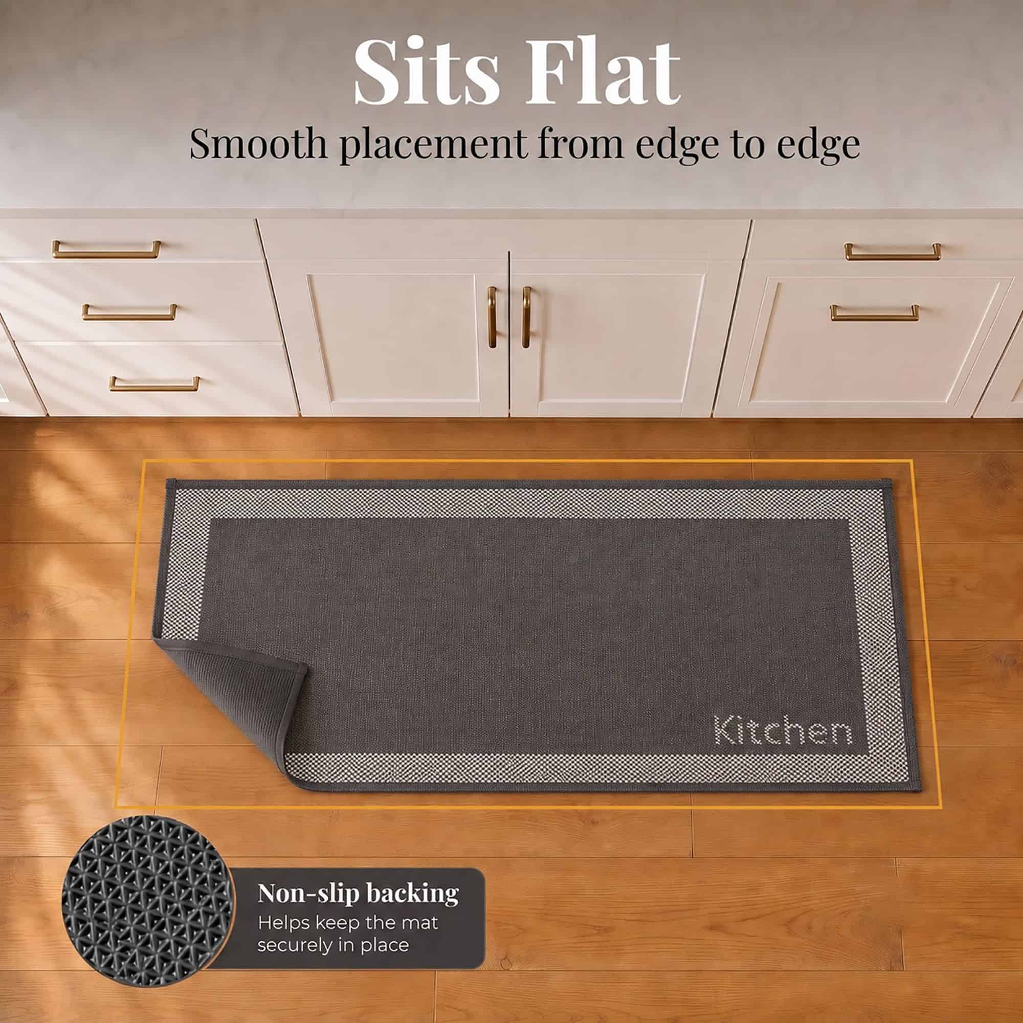 6- Charcoal and cream kitchen runner with Kitchen word lying flat, corner folded to show non slip backing on wood floor