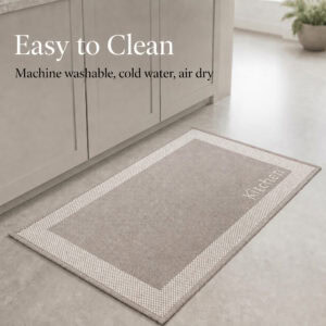 7- Taupe kitchen mat with cream border and Kitchen word on tile floor, machine washable in cold water and air dry