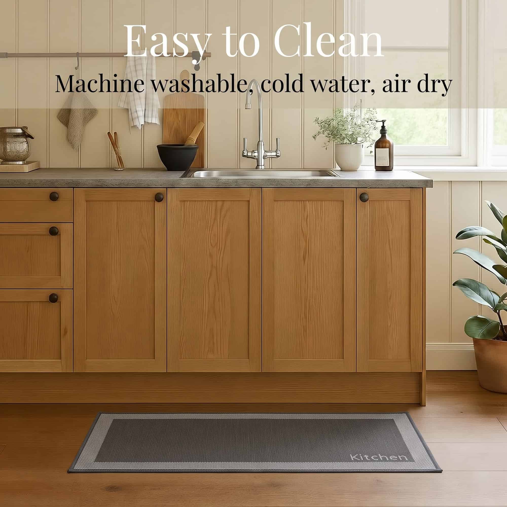7- Charcoal and cream bordered kitchen runner with Kitchen word on wood floor, machine washable in cold water and air dry