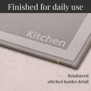 8- Close-up of taupe kitchen mat corner with woven Kitchen word and reinforced stitched border detail