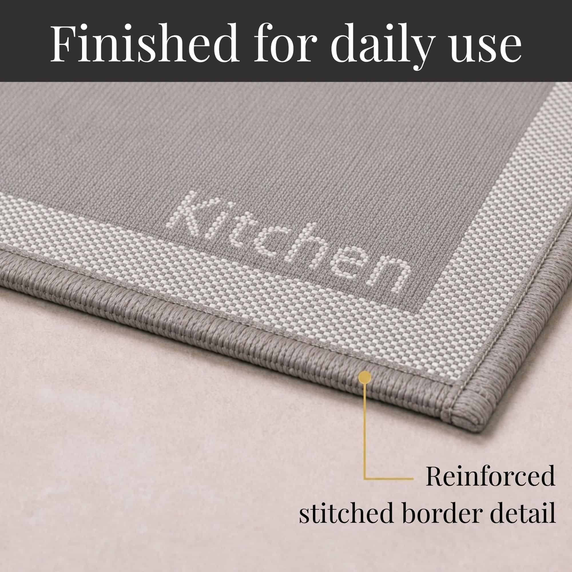 8- Close-up of taupe kitchen mat corner with woven Kitchen word and reinforced stitched border detail